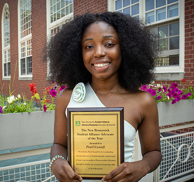 Pearl Gyamfi holding the NBSA Advocate of the Year Award