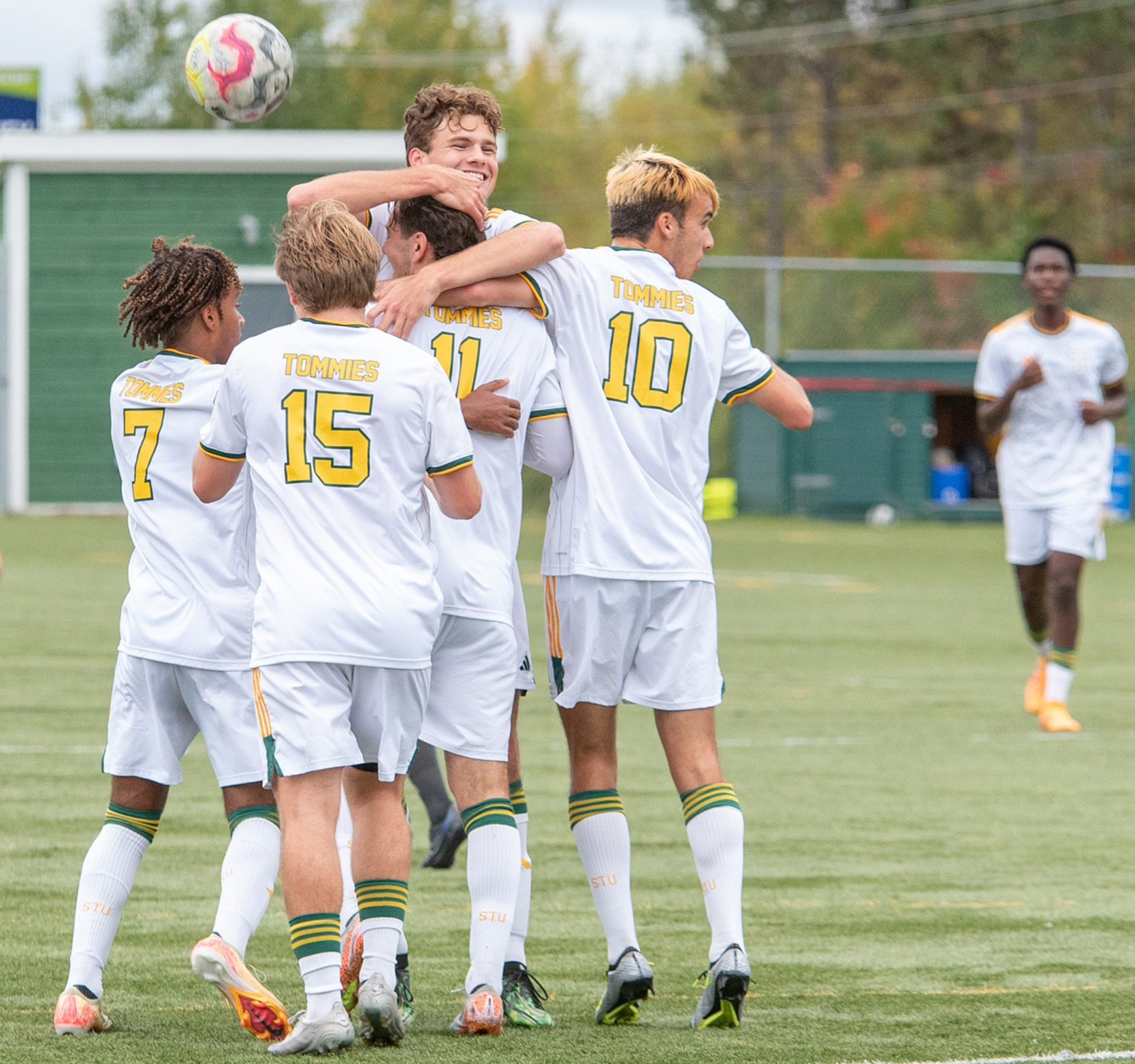 Tommies Men's Soccer players celebrate at midfield