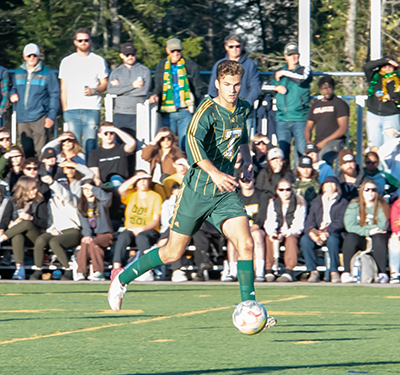 STU athlete playing soccer match with crowd in background