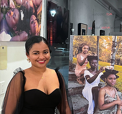 Student Sydona Chandon posed in front of one of her artworks at gallery exhibit opening