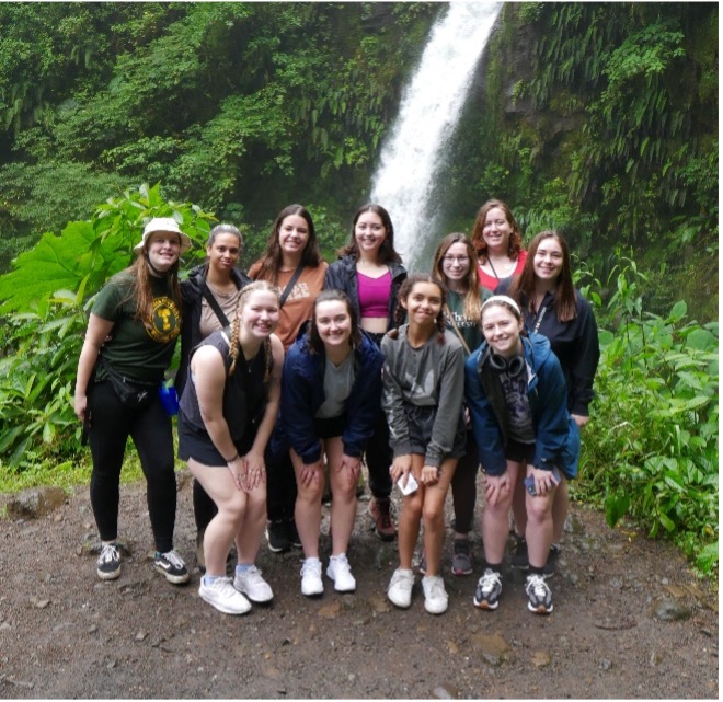 Group of students in costa rica standing in front of waterfall