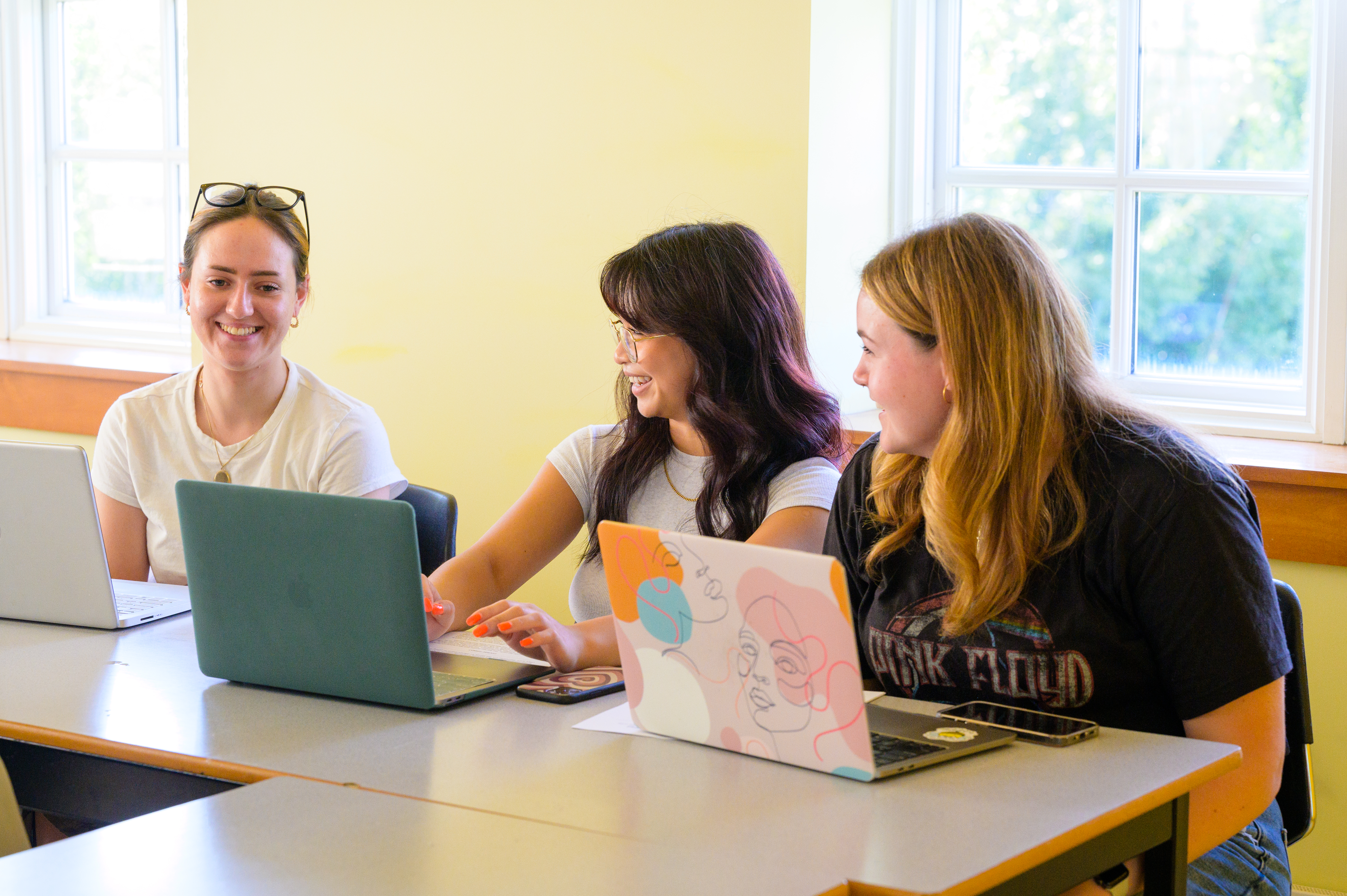 Three students smiling in class