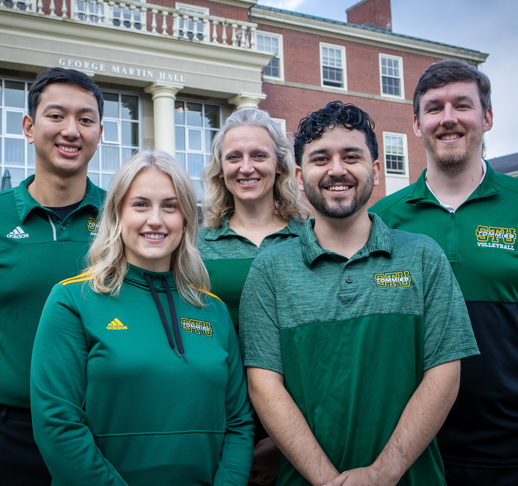 Athletics and Recreation staff standing in front of George Martin Hall