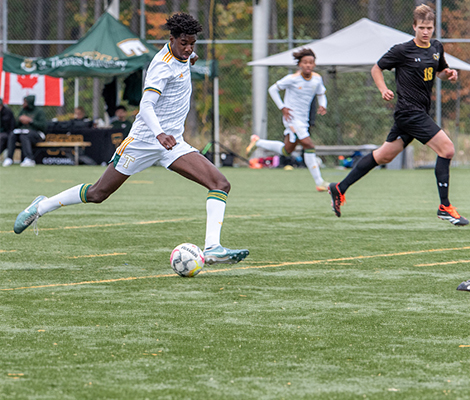 Tommies male athlete playing soccer on field