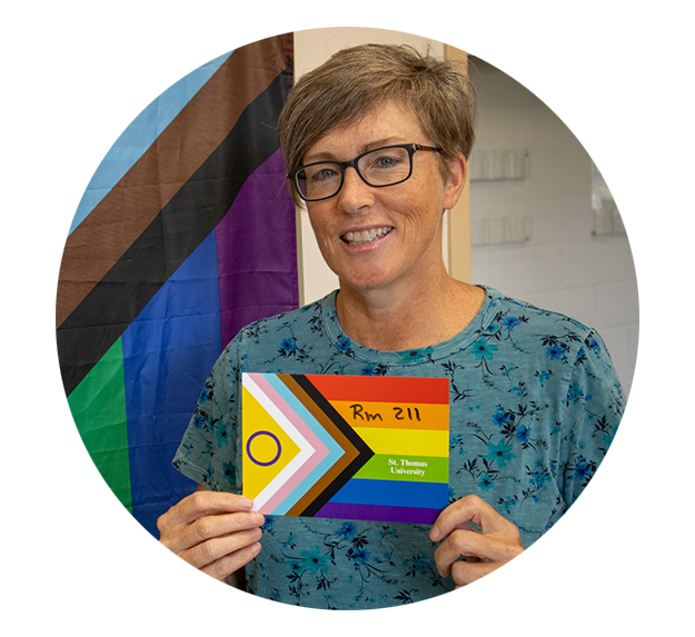 Gail Costello holding pride postcard