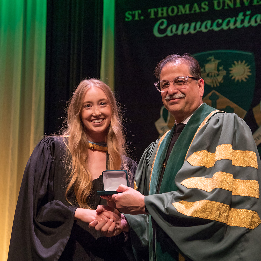 Kennedy Longaphie presented with medal by Dr. Farooqi